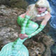Mermaid sitting by Beach